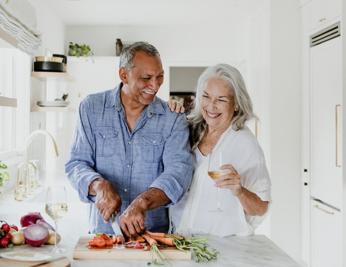 Senior couple cooking together smiling